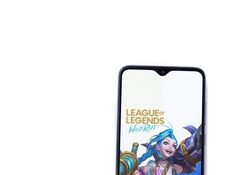 Lod, Israel - July 16,2023: League of Legends - Wild Rift app launch screen on smartphone on white background. Top view flat lay with copy space.