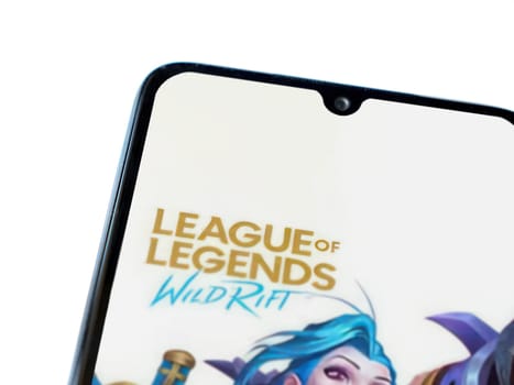 Lod, Israel - July 16,2023: League of Legends - Wild Rift app launch screen on smartphone on white background. Top view flat lay with copy space.
