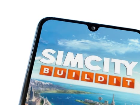 Lod, Israel - July 16,2023: SimCity BuildIt app launch screen on smartphone on white background. Top view flat lay with copy space.