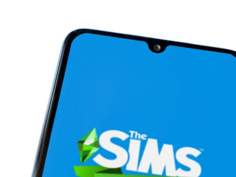 Lod, Israel - July 16,2023: The Sims Mobile app launch screen on smartphone on white background. Top view flat lay with copy space.