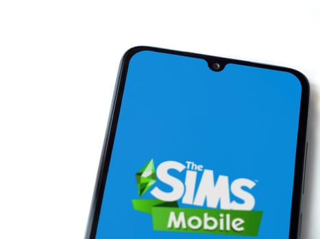 Lod, Israel - July 16,2023: The Sims Mobile app launch screen on smartphone on white background. Top view flat lay with copy space.