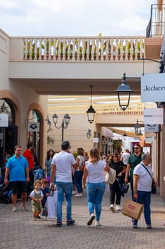 Agira, Sicily, Italy - 30 Sep 2023. Sicilia Outlet Village shopping centre is a popular visitor magnet. People shopping at Sicilia Outlet Village.
