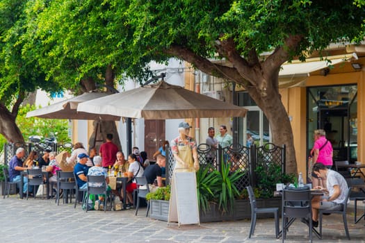 Messina, Italy, Sicily - 26 September 2023. Many people in a Messina street café near the harbour.