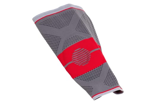 Knee pads isolated. Close-up of a red gray sports elastic knee pad or bandage to fixing and supporting joints. Clipping path. Volleyball, jogging, running or Fitnesstraining.