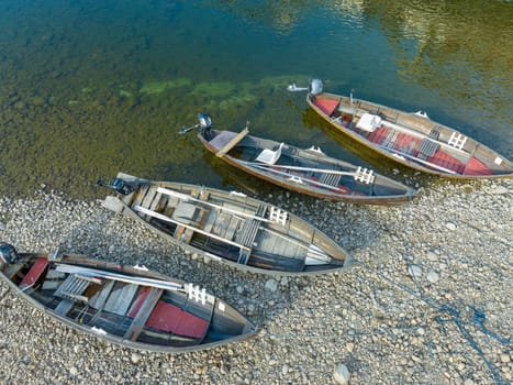 several rowing boats lying along the Namsen river in Norway