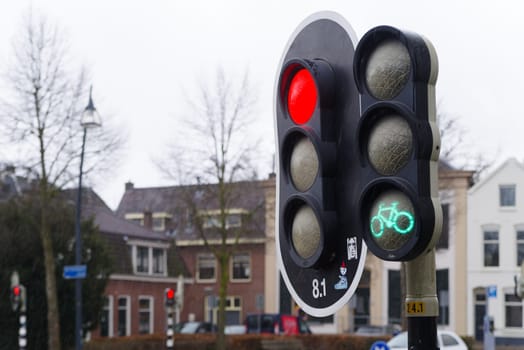 red traffic light for cars and green traffic light for bicycles