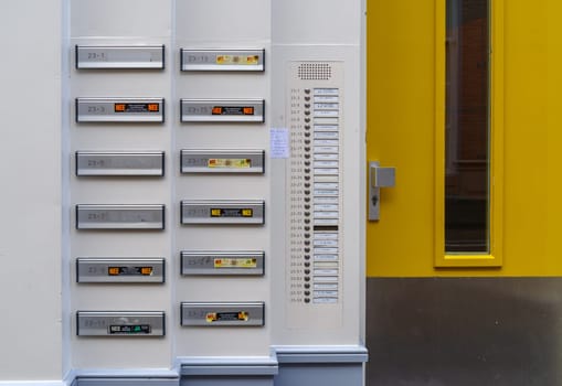 ZWOLLE, NETHERLANDS - MARCH 14, 2021: Lots of doorbells and name plates on an apartment building