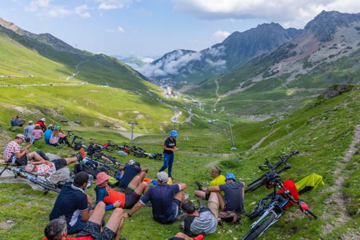 Col du Tourmalet, France - July 06 2023: Cycling fans waiting for the buch at the top of the Col du Tourmalet in Pyerenees mountains during the stage 6 of Le Tour de France 2023