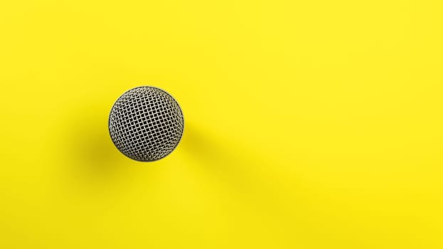 Microphone on yellow board, direct top down view, only ball with grid visible making so it looks abstract.
