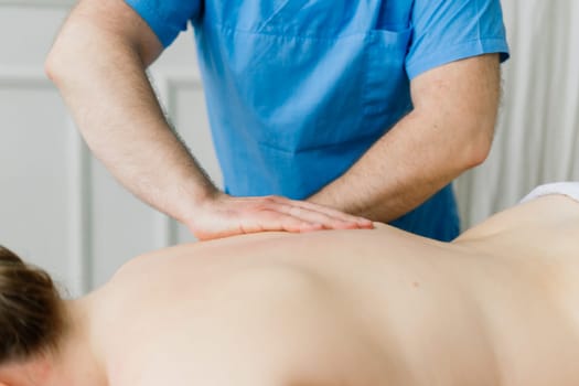 Young fat woman getting massage treatment in a day spa cabinet.