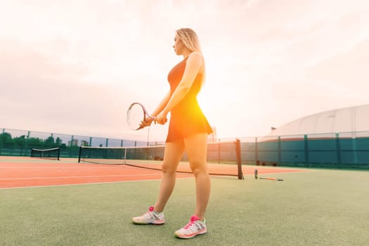 Tennis tournament. Female player at clay tennis court