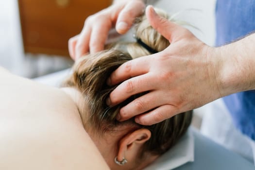 Plump woman getting hot stones arm massage in a spa salon. Therapy, wellness and relaxation concept