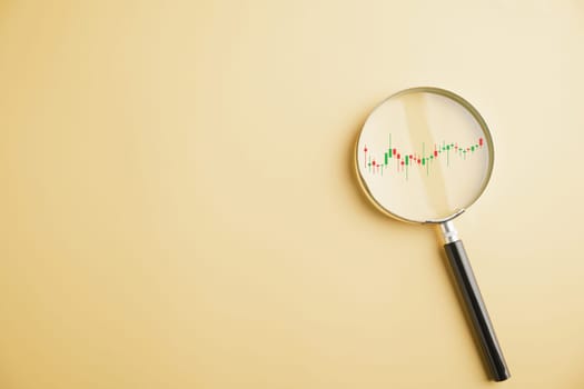 A trader's magnifying glass reveals insights into stock market's bar graph, highlighting upward trend and reflecting potential for profitable business investments. Technical price graph and indicator