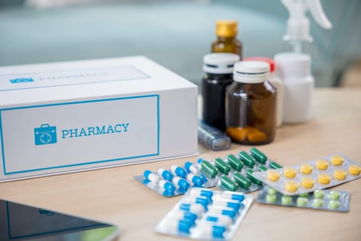 Home medicine with medicine package box free first aid kit with pills from pharmacy hospital delivery service at home on table in living room, online purchase delivery of medicines to your home