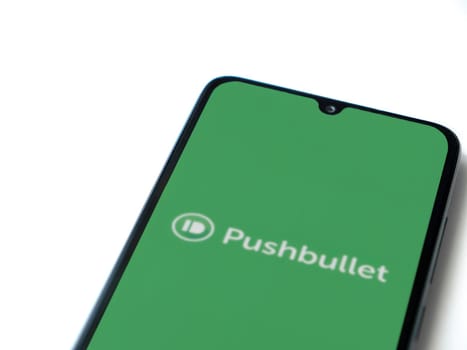 Lod, Israel - July 16,2023: Pushbullet app launch screen on smartphone on white background. Top view flat lay with copy space.