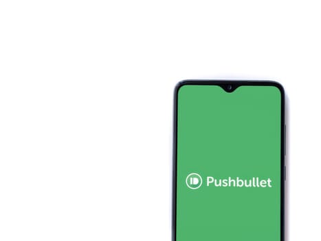 Lod, Israel - July 16,2023: Pushbullet app launch screen on smartphone on white background. Top view flat lay with copy space.