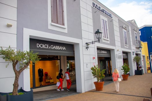 Agira, Sicily, Italy - 30 Sep 2023. Sicilia Outlet Village shopping centre is a popular visitor magnet. Passage with people where shopping at Outlet Village.