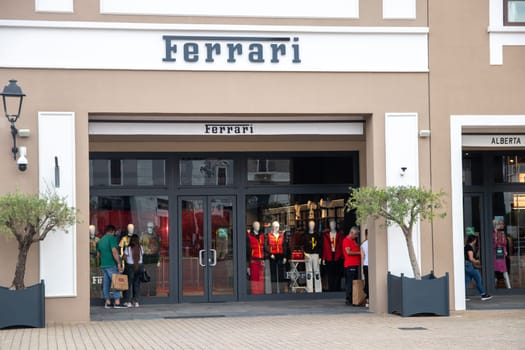 Sicily, Italy, Agira - 30 Sep 2023. The Sicilia Outlet Village shopping centre is a popular visitor magnet. Passage with front of the Ferrari boutique