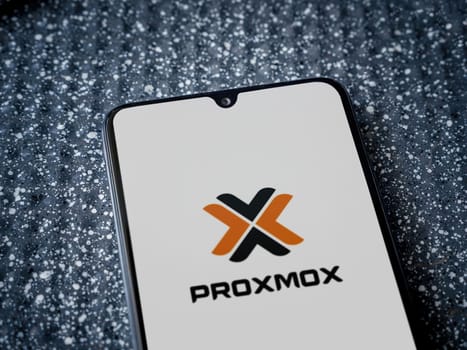 Lod, Israel - July 16,2023: Proxmox Virtual Environment app launch screen on smartphone on metallic background. Close up top view flat lay.