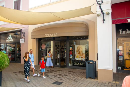 Sicily, Italy, Agira - 30 Sep 2023. Sicilia Outlet Village shopping centre is a popular visitor magnet. People shopping at Sicilia Outlet Village.