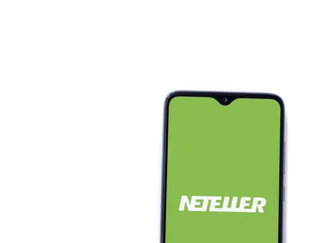 Lod, Israel - July 16,2023: NETELLER app launch screen on smartphone on white background. Top view flat lay with copy space.