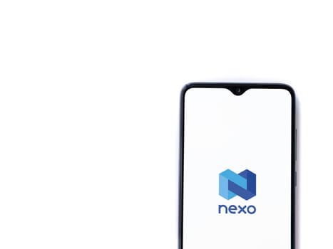 Lod, Israel - July 16,2023: Nexo app launch screen on smartphone on white background. Top view flat lay with copy space.