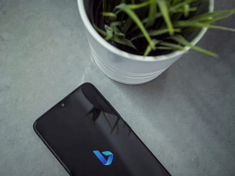 Lod, Israel - July 16,2023: Modern workspace with smartphone with Bing Browser app launch screen on marble background. Close up top view flat lay.