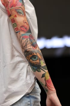 Krakow, Poland - June 12, 2022: Unidentified participant during the contest for the best tattoo at the 15th Tattoofest Convention in Cracow. One of the most prestigious tattoo festivals.