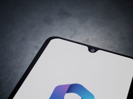 Lod, Israel - July 16,2023: Microsoft 360 app launch screen on smartphone on dark marble stone background. Top view flat lay with copy space.