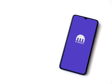 Lod, Israel - July 16,2023: Kraken app launch screen on smartphone on white background. Top view flat lay with copy space.