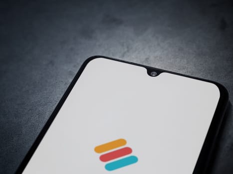 Lod, Israel - July 16,2023: Memorigi app launch screen on smartphone on dark marble stone background. Top view flat lay with copy space.