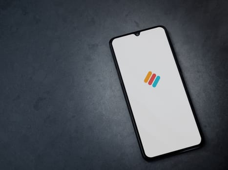 Lod, Israel - July 16,2023: Memorigi app launch screen on smartphone on dark marble stone background. Top view flat lay with copy space.