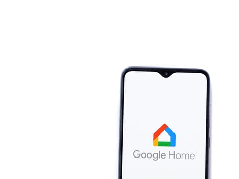 Lod, Israel - July 16,2023: Google Home app launch screen on smartphone on white background. Top view flat lay with copy space.