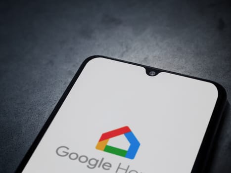 Lod, Israel - July 16,2023: Google Home app launch screen on smartphone on dark marble stone background. Top view flat lay with copy space.