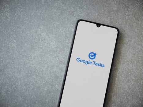 Lod, Israel - July 16,2023: Google Task app launch screen on smartphone on ceramic stone background. Top view flat lay with copy space.