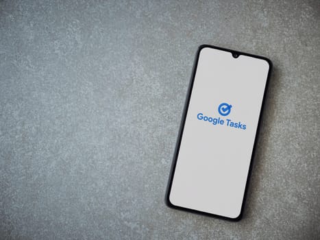 Lod, Israel - July 16,2023: Google Task app launch screen on smartphone on ceramic stone background. Top view flat lay with copy space.
