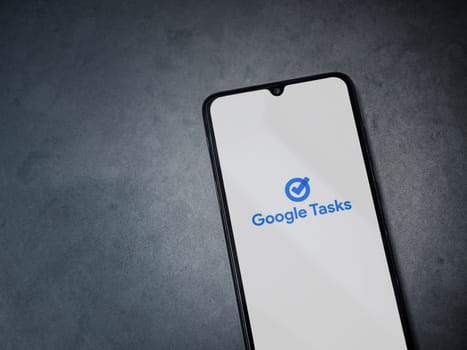 Lod, Israel - July 16,2023: Google Task app launch screen on smartphone on dark marble stone background. Top view flat lay with copy space.
