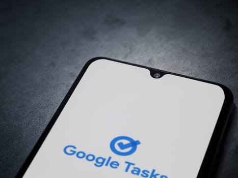 Lod, Israel - July 16,2023: Google Task app launch screen on smartphone on dark marble stone background. Top view flat lay with copy space.