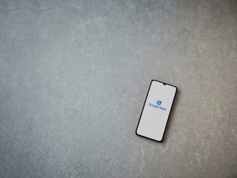 Lod, Israel - July 16,2023: Google Task app launch screen on smartphone on ceramic stone background. Top view flat lay with copy space.