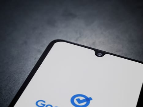 Lod, Israel - July 16,2023: Google Task app launch screen on smartphone on dark marble stone background. Top view flat lay with copy space.