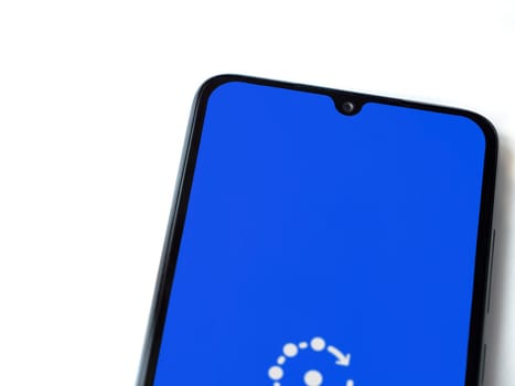 Lod, Israel - July 16,2023: Fing app launch screen on smartphone on white background. Top view flat lay with copy space.