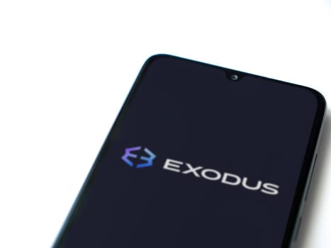 Lod, Israel - July 16,2023: Exodus app launch screen on smartphone on white background. Top view flat lay with copy space.