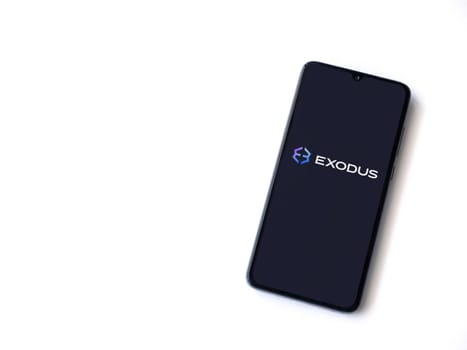 Lod, Israel - July 16,2023: Exodus app launch screen on smartphone on white background. Top view flat lay with copy space.