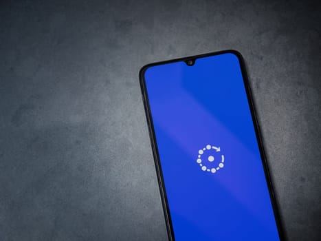 Lod, Israel - July 16,2023: Fing app launch screen on smartphone on dark marble stone background. Top view flat lay with copy space.