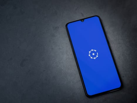 Lod, Israel - July 16,2023: Fing app launch screen on smartphone on dark marble stone background. Top view flat lay with copy space.
