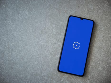 Lod, Israel - July 16,2023: Fing app launch screen on smartphone on ceramic stone background. Top view flat lay with copy space.