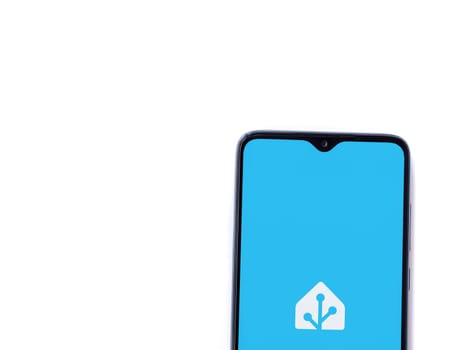 Lod, Israel - July 16,2023: Home Assistant app launch screen on smartphone on white background. Top view flat lay with copy space.
