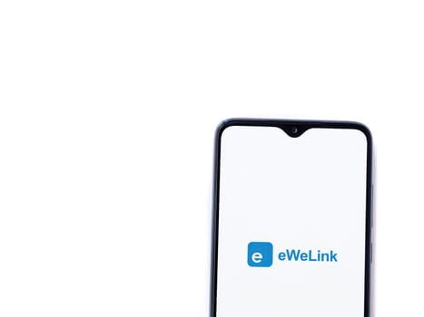 Lod, Israel - July 16,2023: eWeLink app launch screen on smartphone on white background. Top view flat lay with copy space.