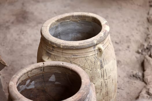 Santorini, Greece - July 01, 2021: Recovered ancient pottery in prehistoric town of Akrotiri, excavation site of a Minoan Bronze Age settlement on the Greek island of Santorini