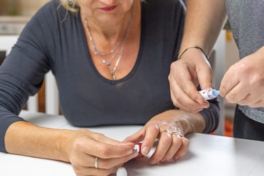 Male hands prepare blood lamcets for woman to measure  blood sugar level. Horizontally.
